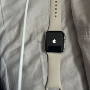 Apple Smartwatch with Black Display and Cream Band